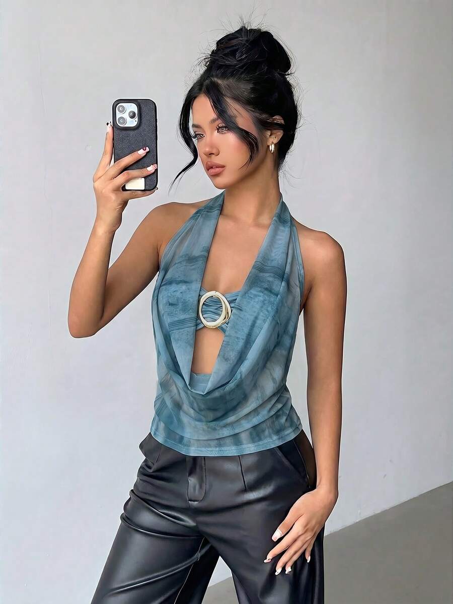 Brown and white polka dot semi-sheer halter camisole top with a plunging neckline, backless design, draped front, and metallic studded embellishments.