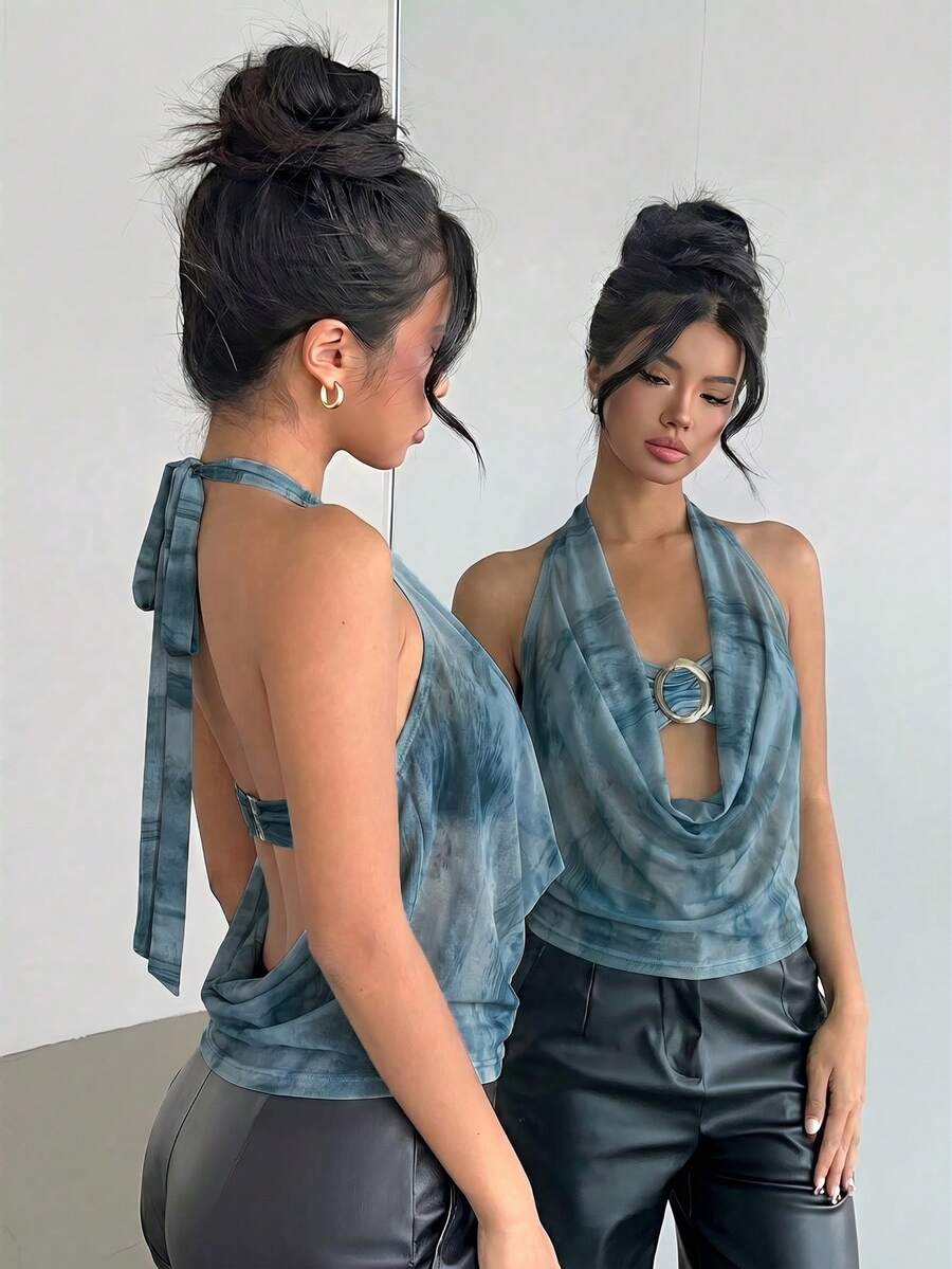 Brown and white polka dot semi-sheer halter camisole top with a plunging neckline, backless design, draped front, and metallic studded embellishments.