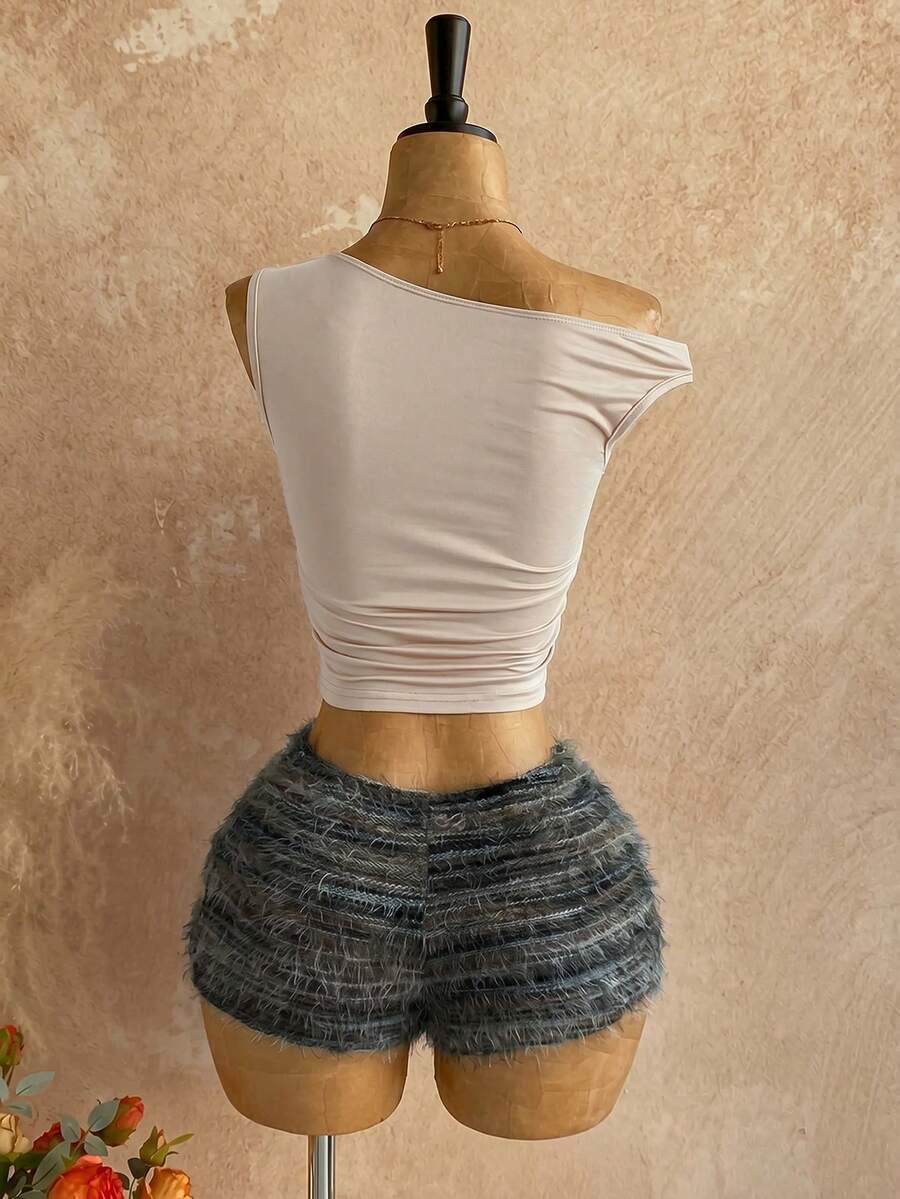 Women's black fuzzy knit two-piece set with an asymmetrical crop camisole top featuring ruched detail and cutout back, paired with matching mini shorts.