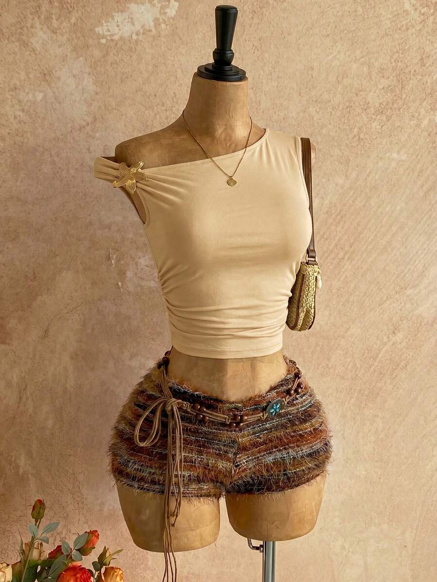 Women's black fuzzy knit two-piece set with an asymmetrical crop camisole top featuring ruched detail and cutout back, paired with matching mini shorts.