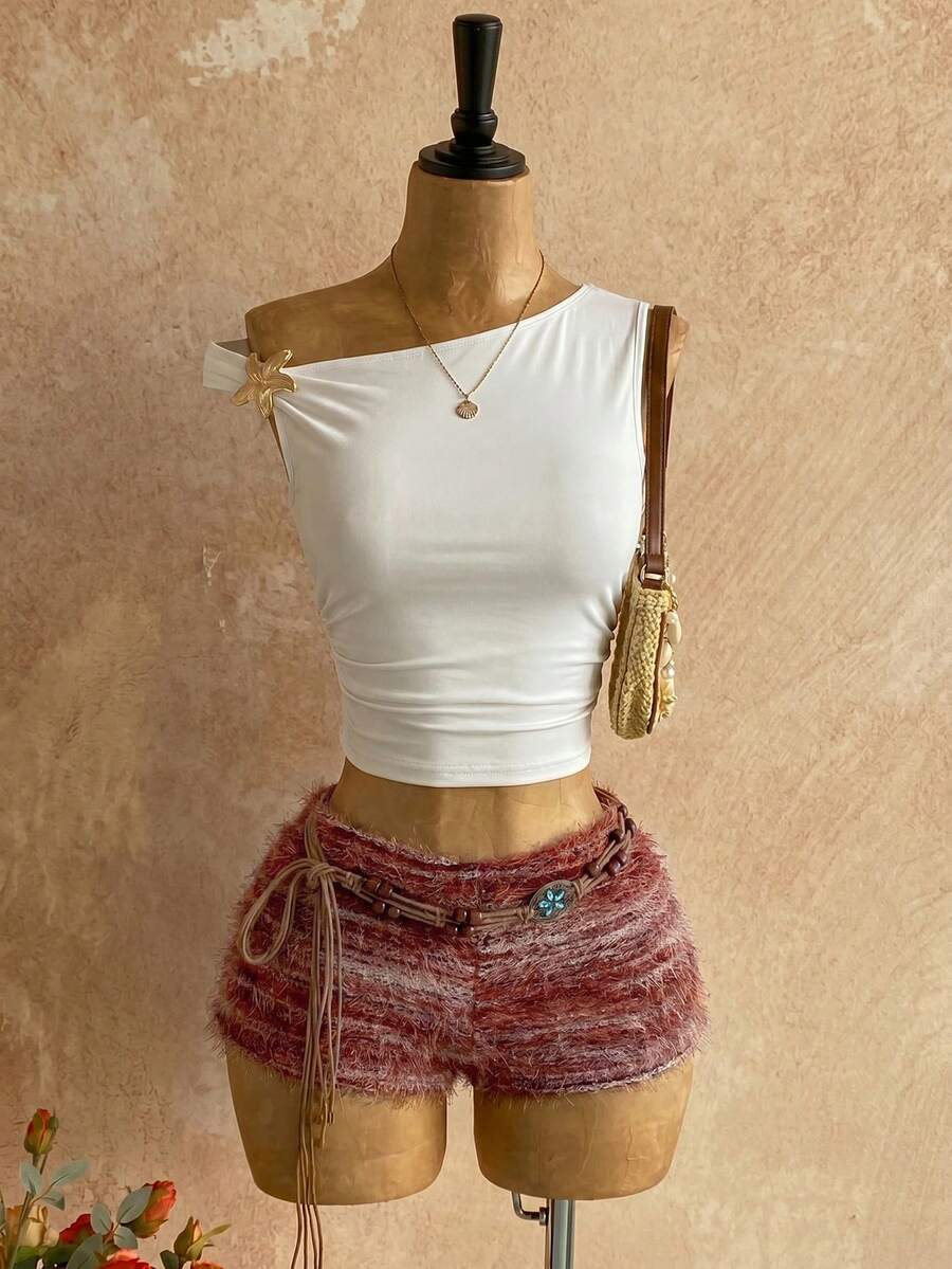 Women's black fuzzy knit two-piece set with an asymmetrical crop camisole top featuring ruched detail and cutout back, paired with matching mini shorts.