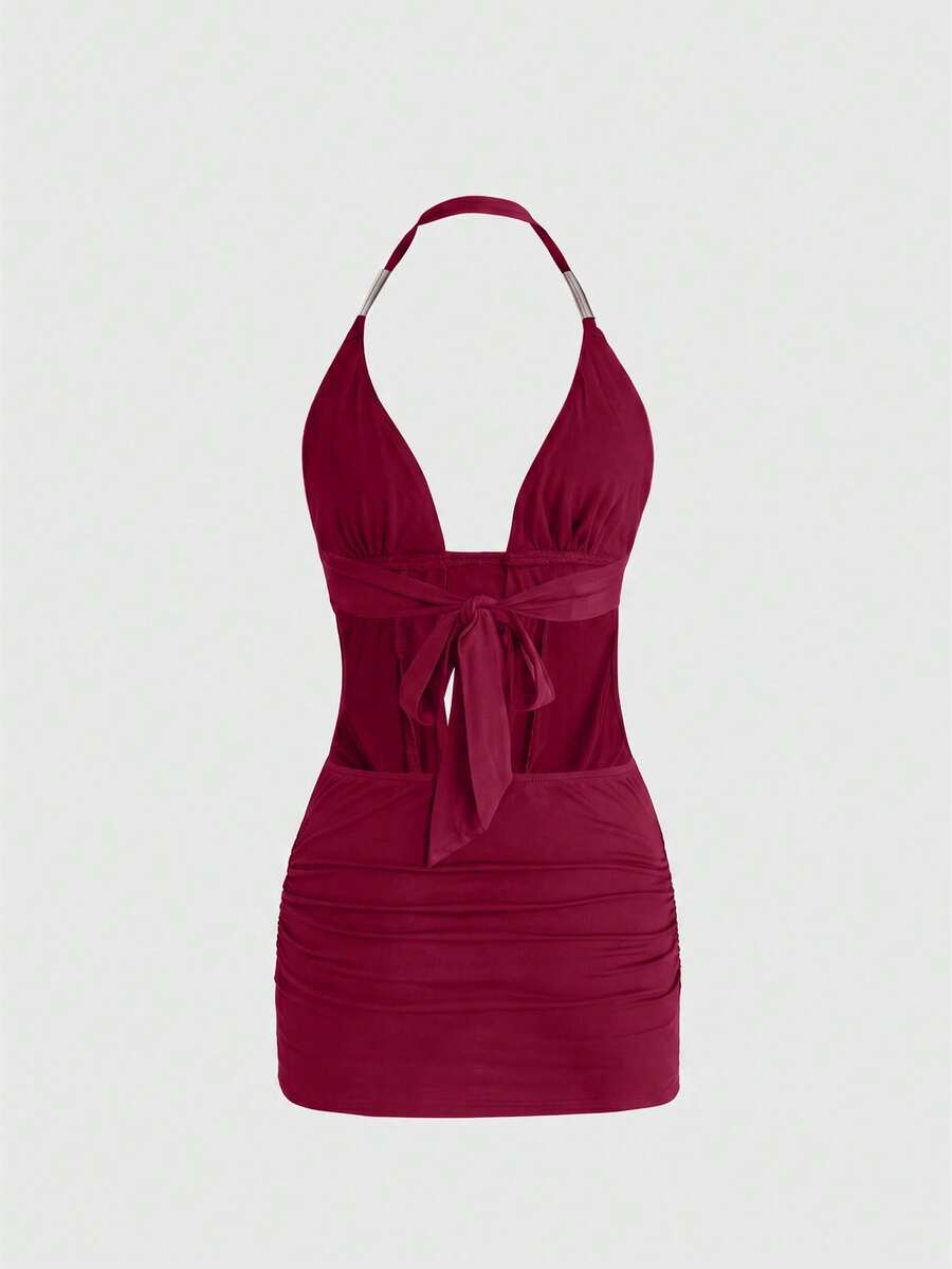Women's slim fit halter neck bodycon mini dress featuring a backless design with knot tie back details.