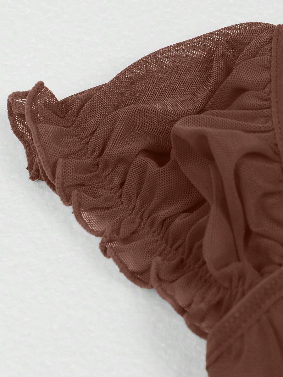 Front view of a vintage lace corset crop top featuring boned structure, square neckline, and lace-up details.
