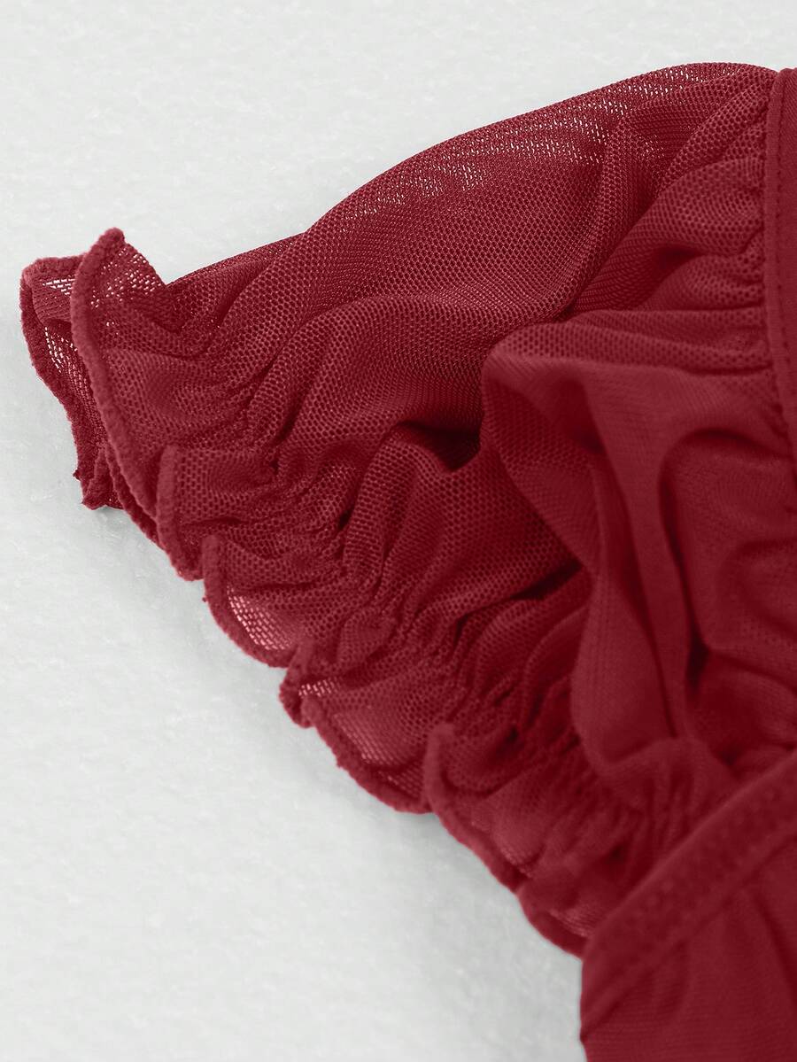 Front view of a vintage lace corset crop top featuring boned structure, square neckline, and lace-up details.