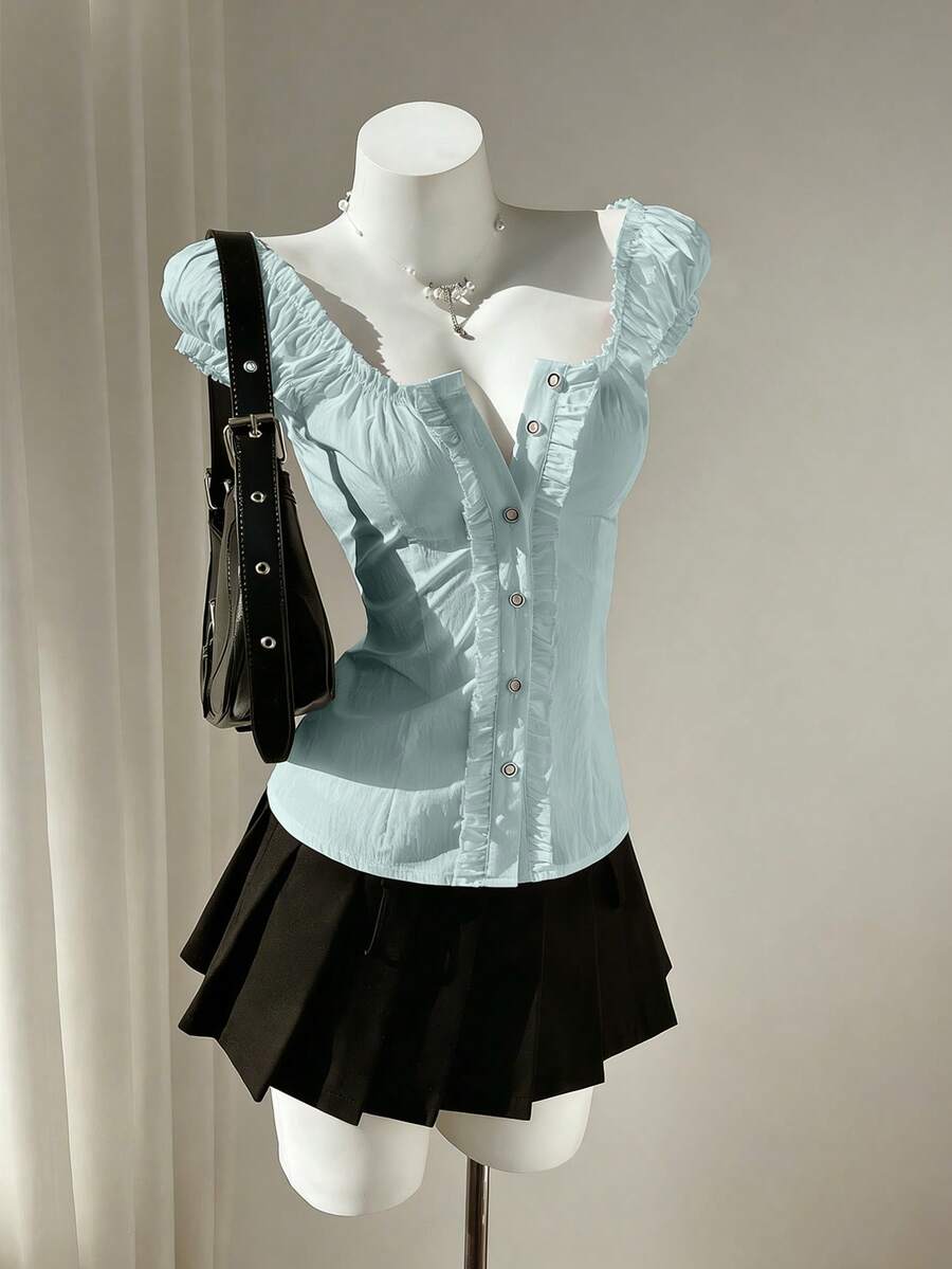 Women's black off-shoulder cap sleeve blouse with ruffled detailing and a tie-back design.
