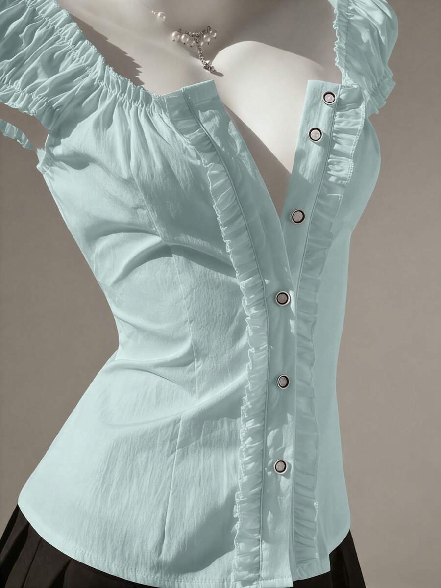 Women's black off-shoulder cap sleeve blouse with ruffled detailing and a tie-back design.