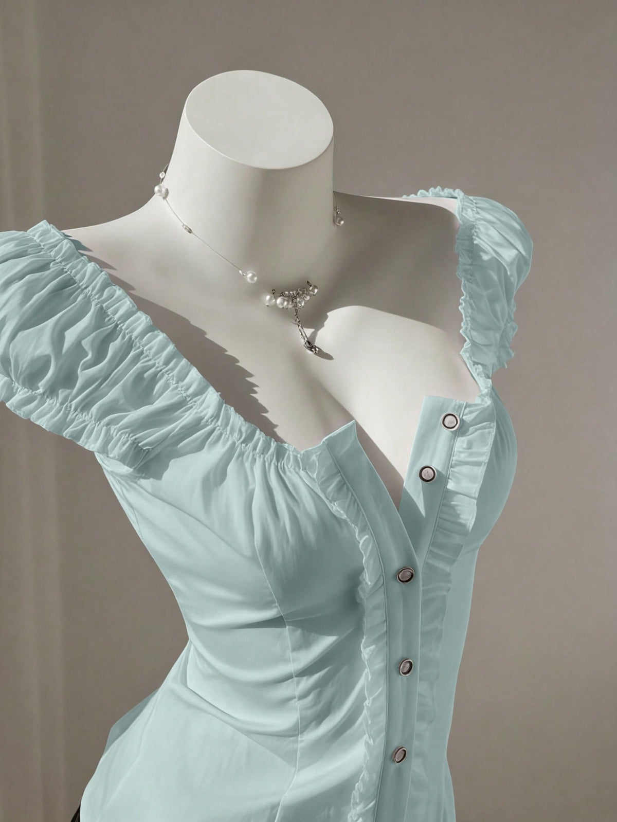 Women's black off-shoulder cap sleeve blouse with ruffled detailing and a tie-back design.