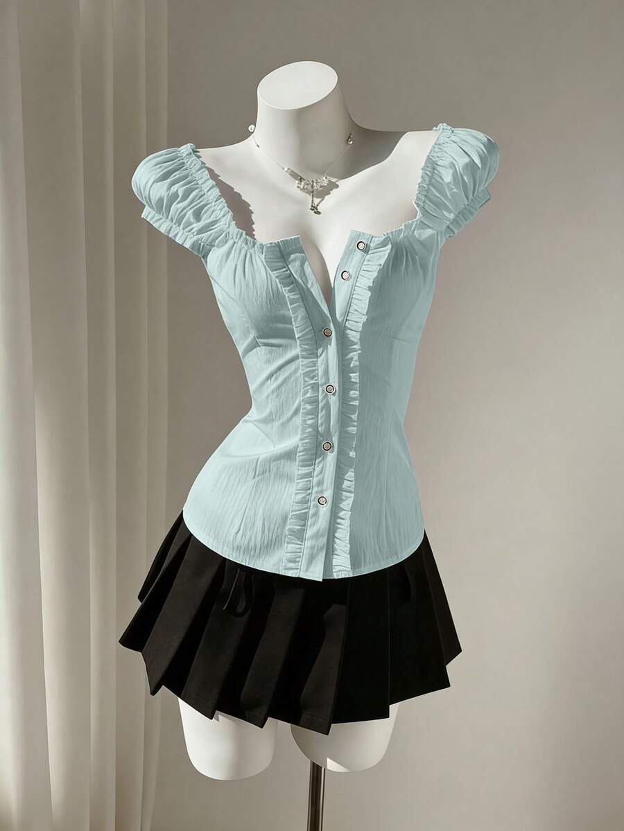 Women's black off-shoulder cap sleeve blouse with ruffled detailing and a tie-back design.