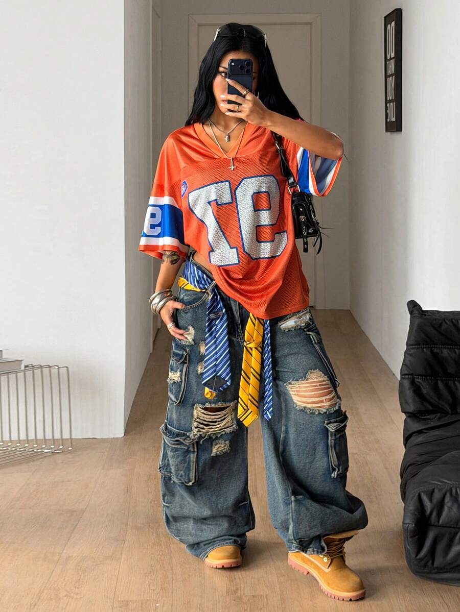 Women's oversized mesh jersey t-shirt with sporty number print, short drop-shoulder sleeves, and V-neckline.