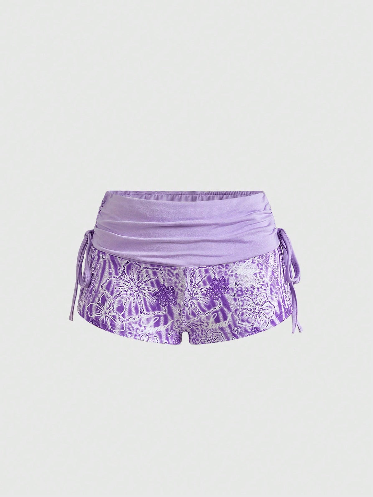 Women's low waist mini track shorts with elastic waistband, drawstring knot, ruched details, and plant pattern in a Y2K boho style