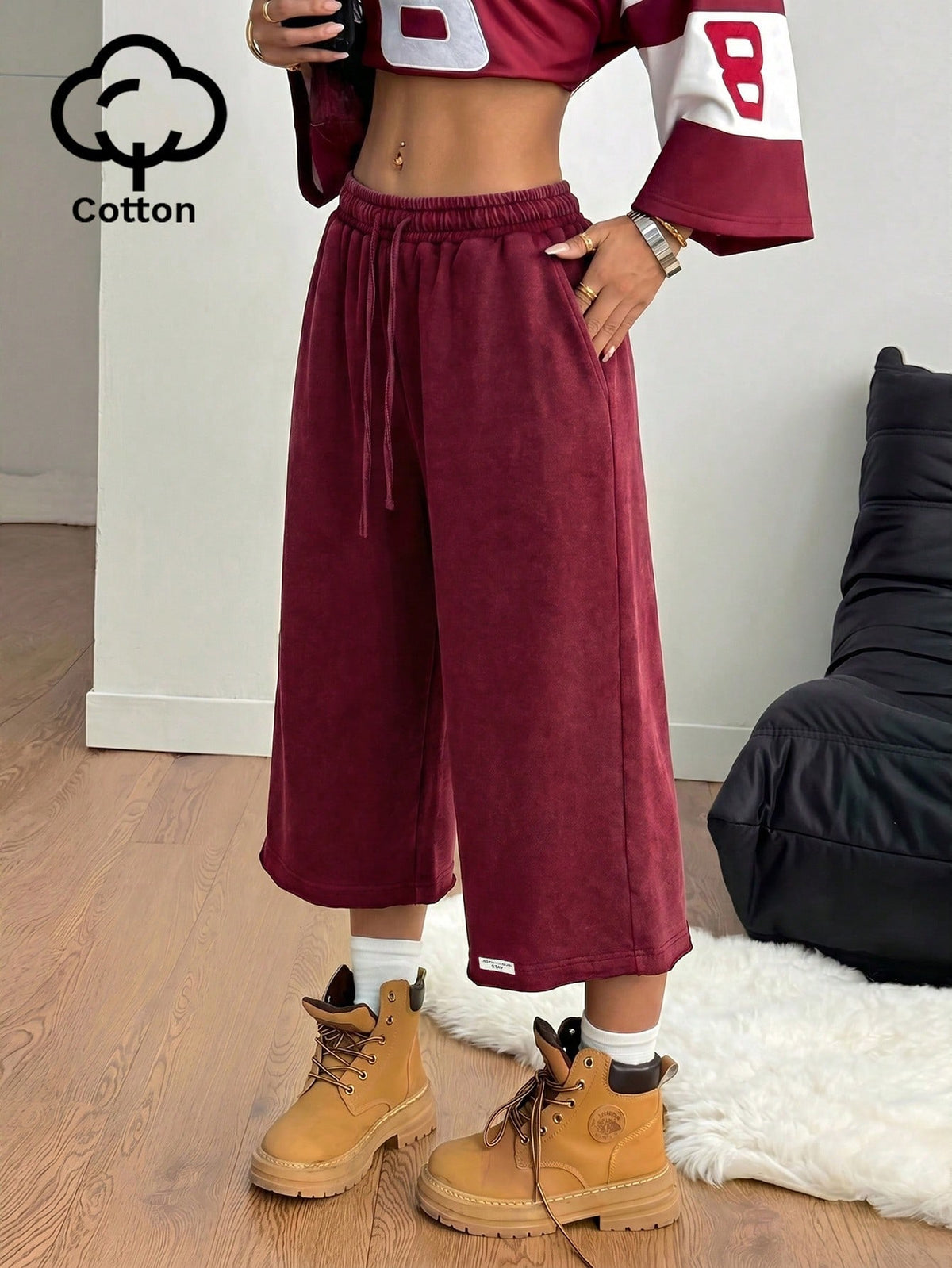 Red women's casual Bermuda track shorts with an elastic drawstring waist, side pockets, and relaxed loose fit.