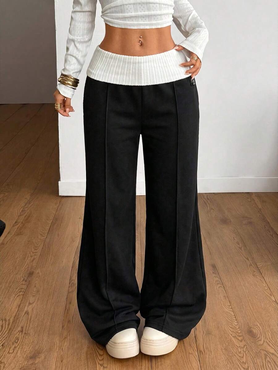 Women's wide leg flare lounge pants made of 95% cotton with a low elastic waistband and extra long hem.