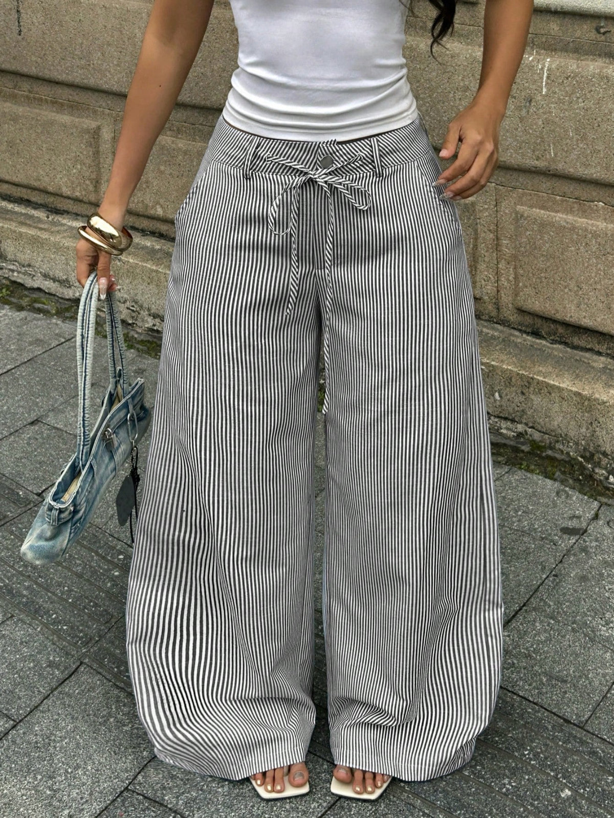 Women's casual straight leg striped woven pants featuring a low waist and zipper fly closure.
