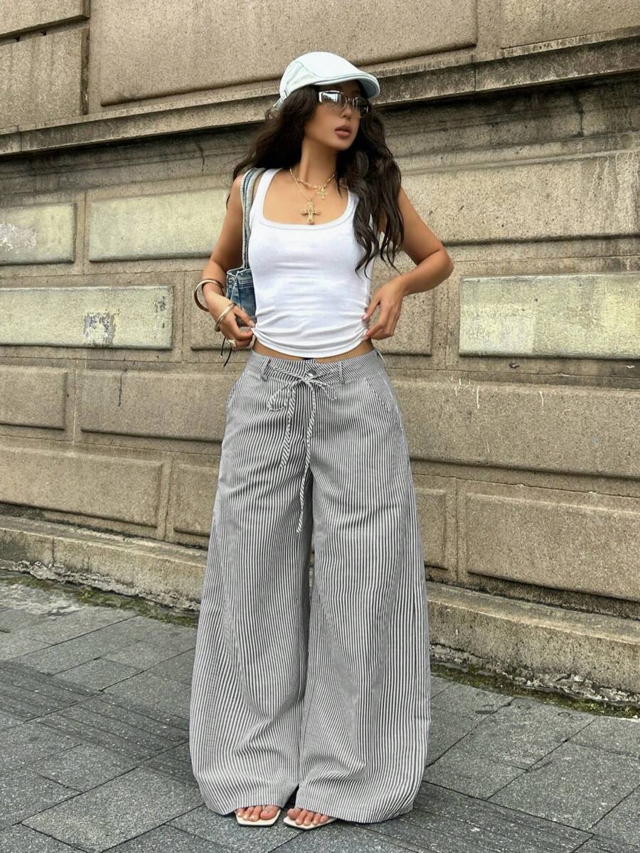 Women's casual straight leg striped woven pants featuring a low waist and zipper fly closure.