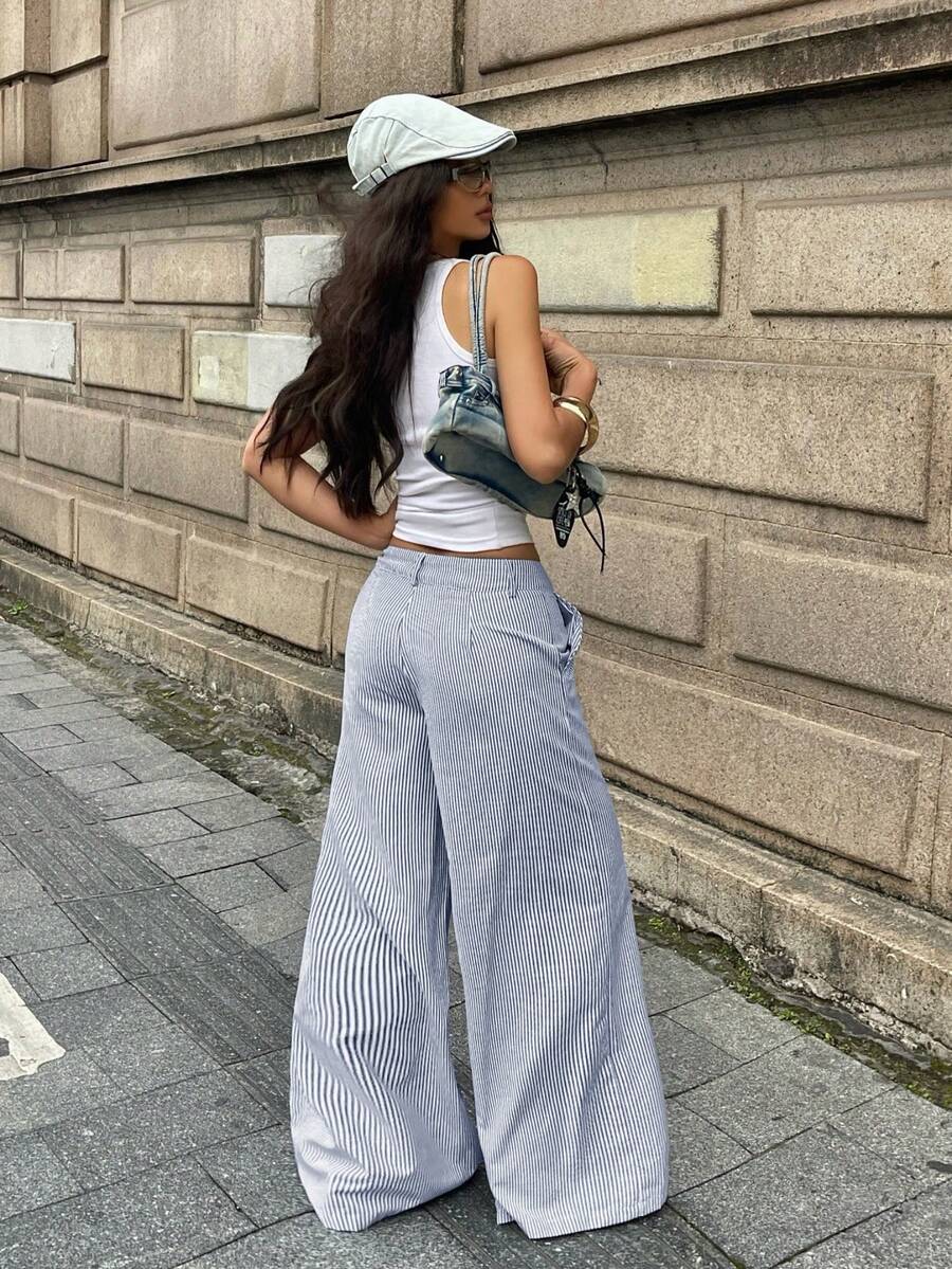 Women's casual straight leg striped woven pants featuring a low waist and zipper fly closure.
