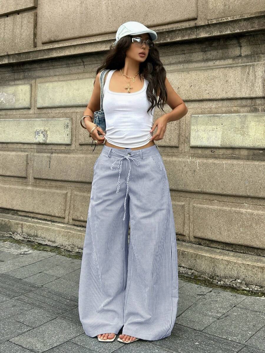 Women's casual straight leg striped woven pants featuring a low waist and zipper fly closure.