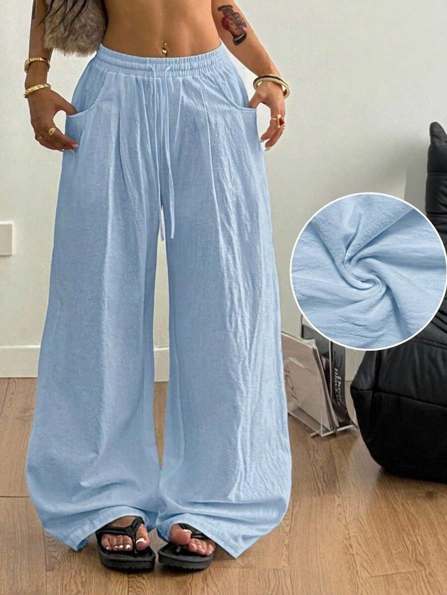 Baby blue women's wide leg baggy pants made of 100% cotton woven fabric with an elastic drawstring waist and side pockets