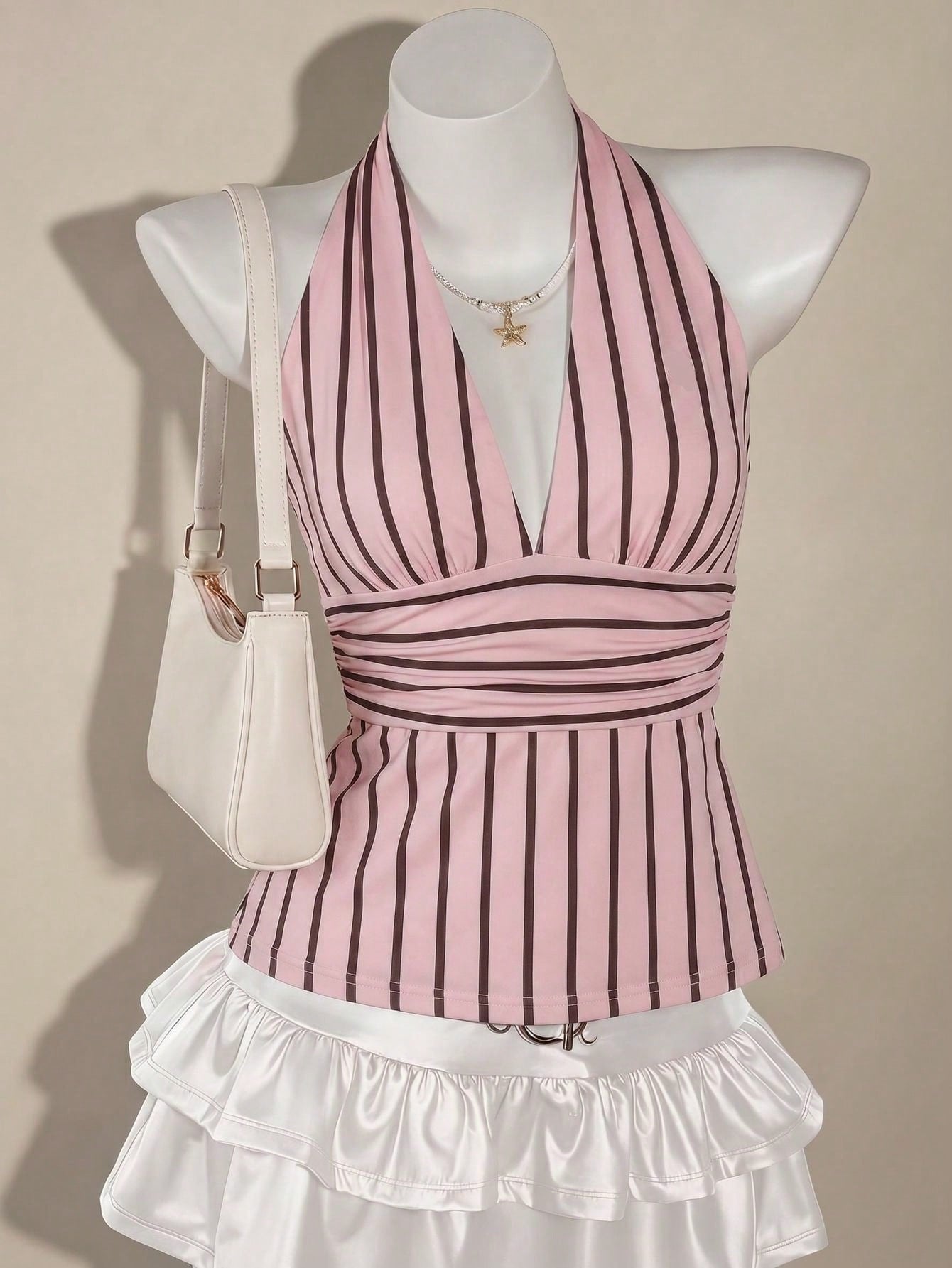 White women's deep V-neck halter tank top with ruched waist, backless design, rib-knit texture, and ruffle hem