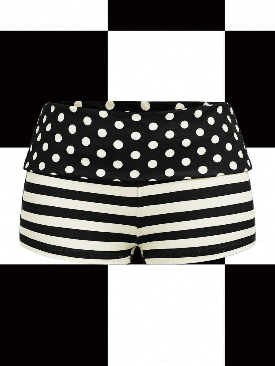 Women's black low waist mini track shorts with contrast polka dot, striped, geometric, and plant-inspired print details, elastic waistband, and skinny fit