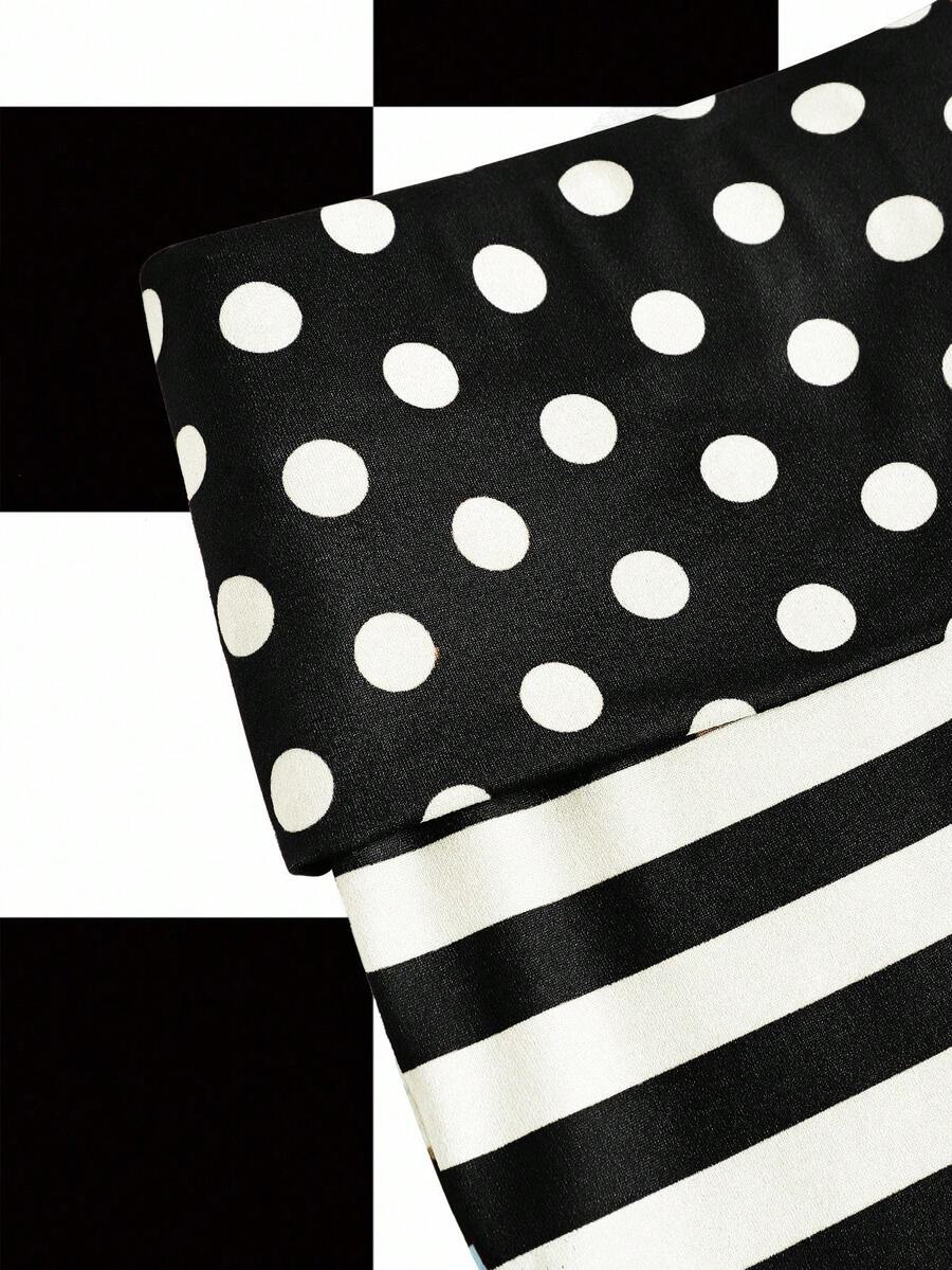 Women's black low waist mini track shorts with contrast polka dot, striped, geometric, and plant-inspired print details, elastic waistband, and skinny fit