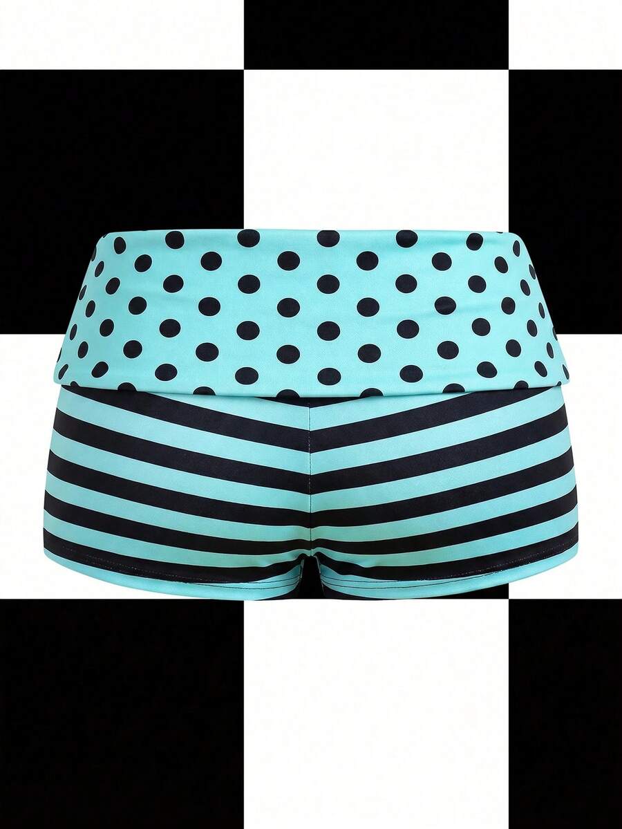 Women's black low waist mini track shorts with contrast polka dot, striped, geometric, and plant-inspired print details, elastic waistband, and skinny fit