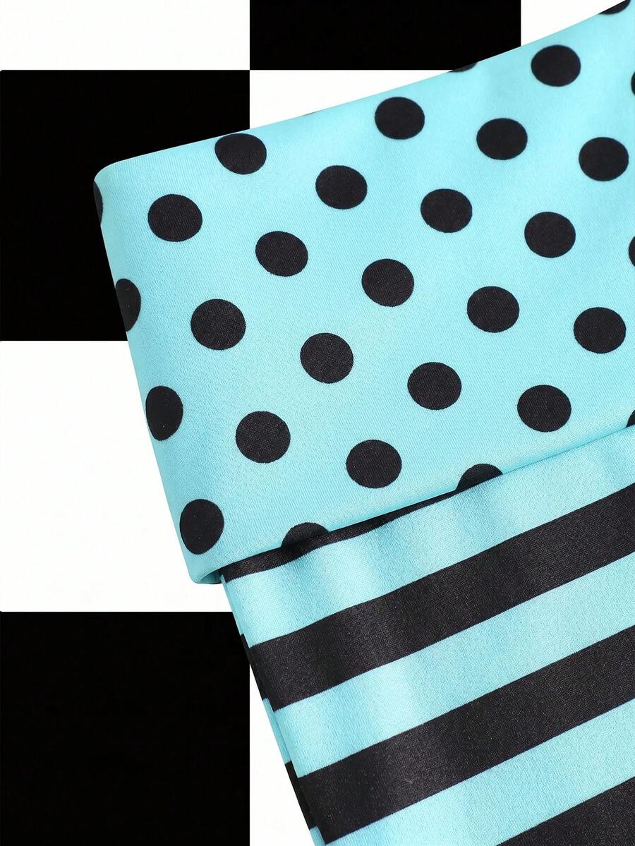 Women's black low waist mini track shorts with contrast polka dot, striped, geometric, and plant-inspired print details, elastic waistband, and skinny fit