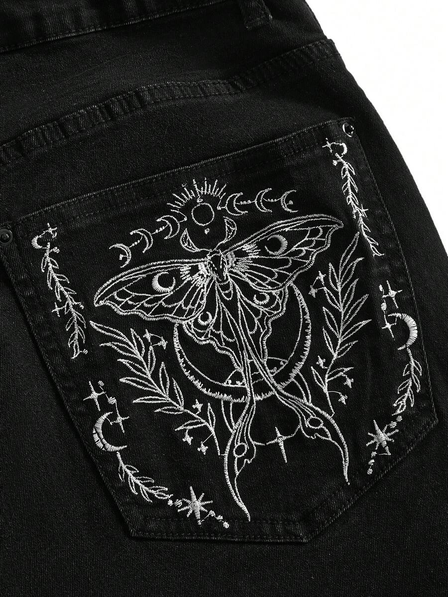 Plus size black gothic mini shorts with heart embroidery, graphic pocket pattern, lace-up detail, raw hem, and zipper fly
