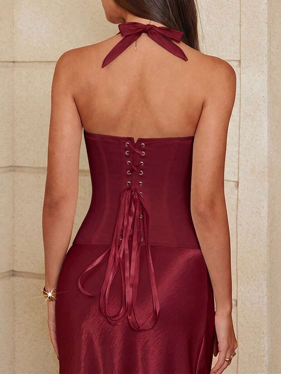 White halter sleeveless cropped camisole top featuring a boned cup detail bust, slim fit waist, and lace-up back closure.