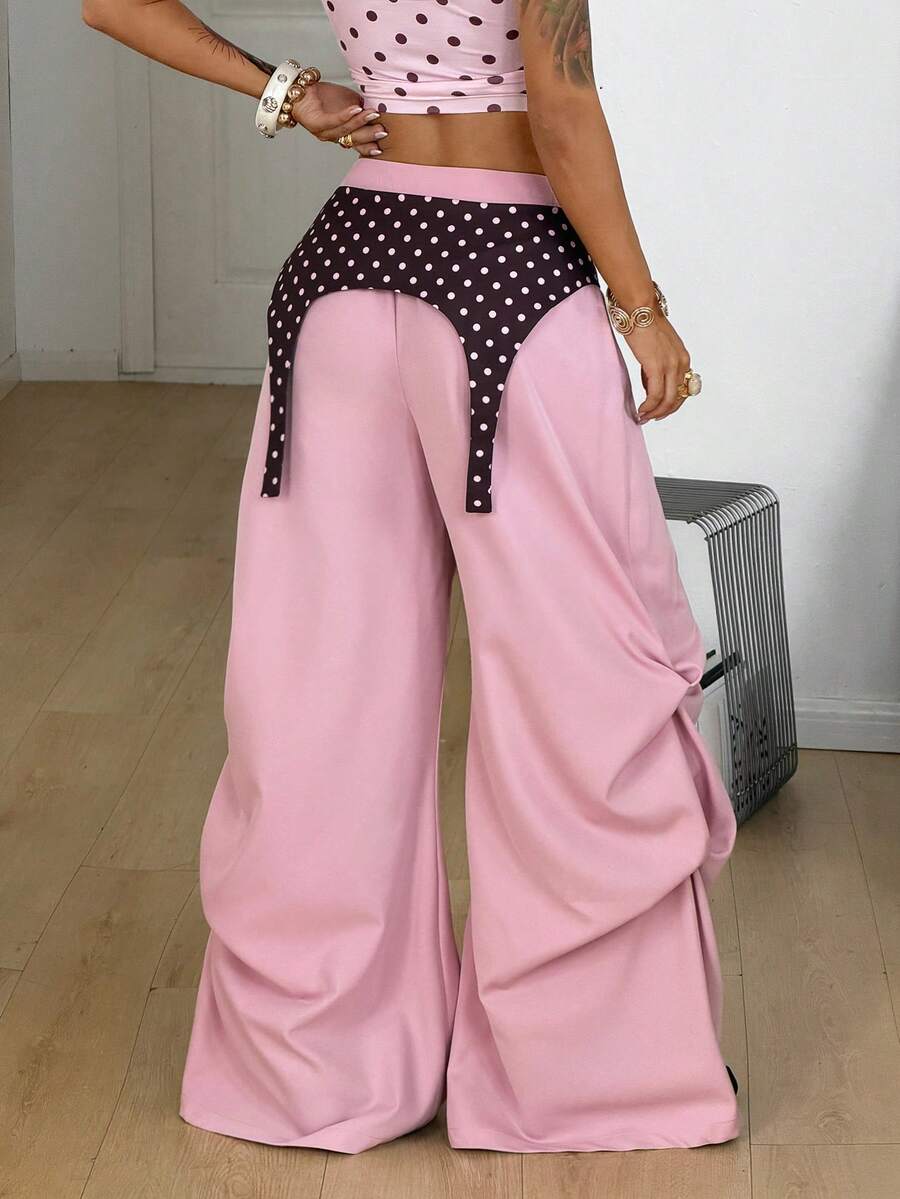 Women's brown baggy parachute pants with polka dot graphic print, low waist, and loose streetwear fit