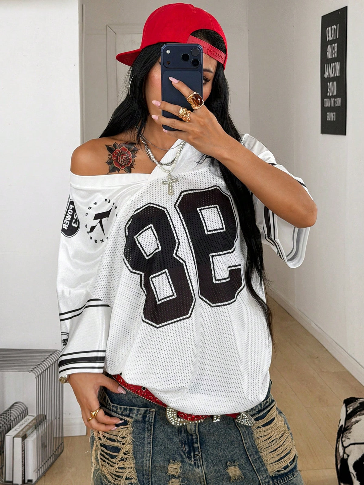 Women's oversized mesh jersey t-shirt with sporty number print, short drop-shoulder sleeves, and V-neckline.