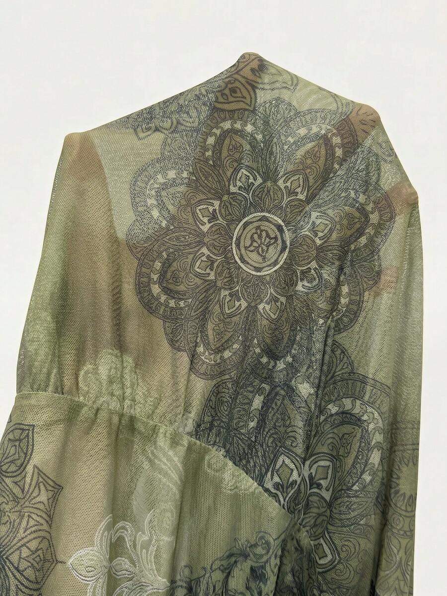 Women's low rise flared long skirt featuring an all-over print, split thigh accent, and textured semi-sheer fabric.