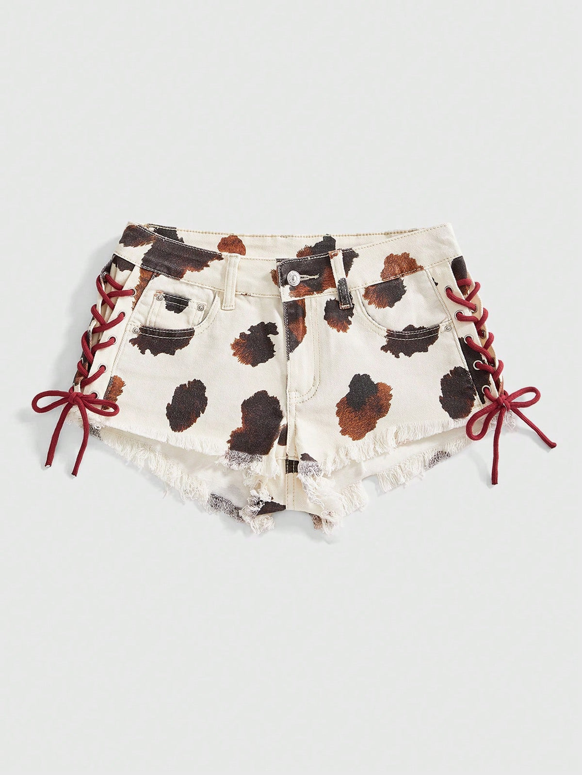 Women's Y2K low waist camo mini skort shorts featuring lace-up knot details, grommet eyelets, graphic lettering pattern, and a zipper fly.