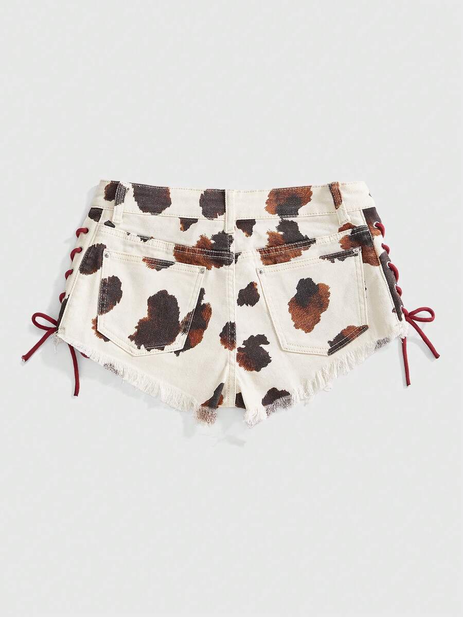 Women's Y2K low waist camo mini skort shorts featuring lace-up knot details, grommet eyelets, graphic lettering pattern, and a zipper fly.