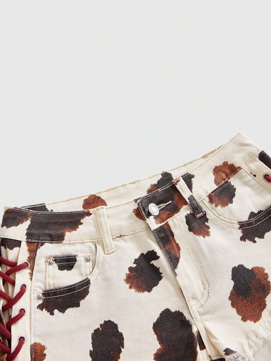 Women's Y2K low waist camo mini skort shorts featuring lace-up knot details, grommet eyelets, graphic lettering pattern, and a zipper fly.