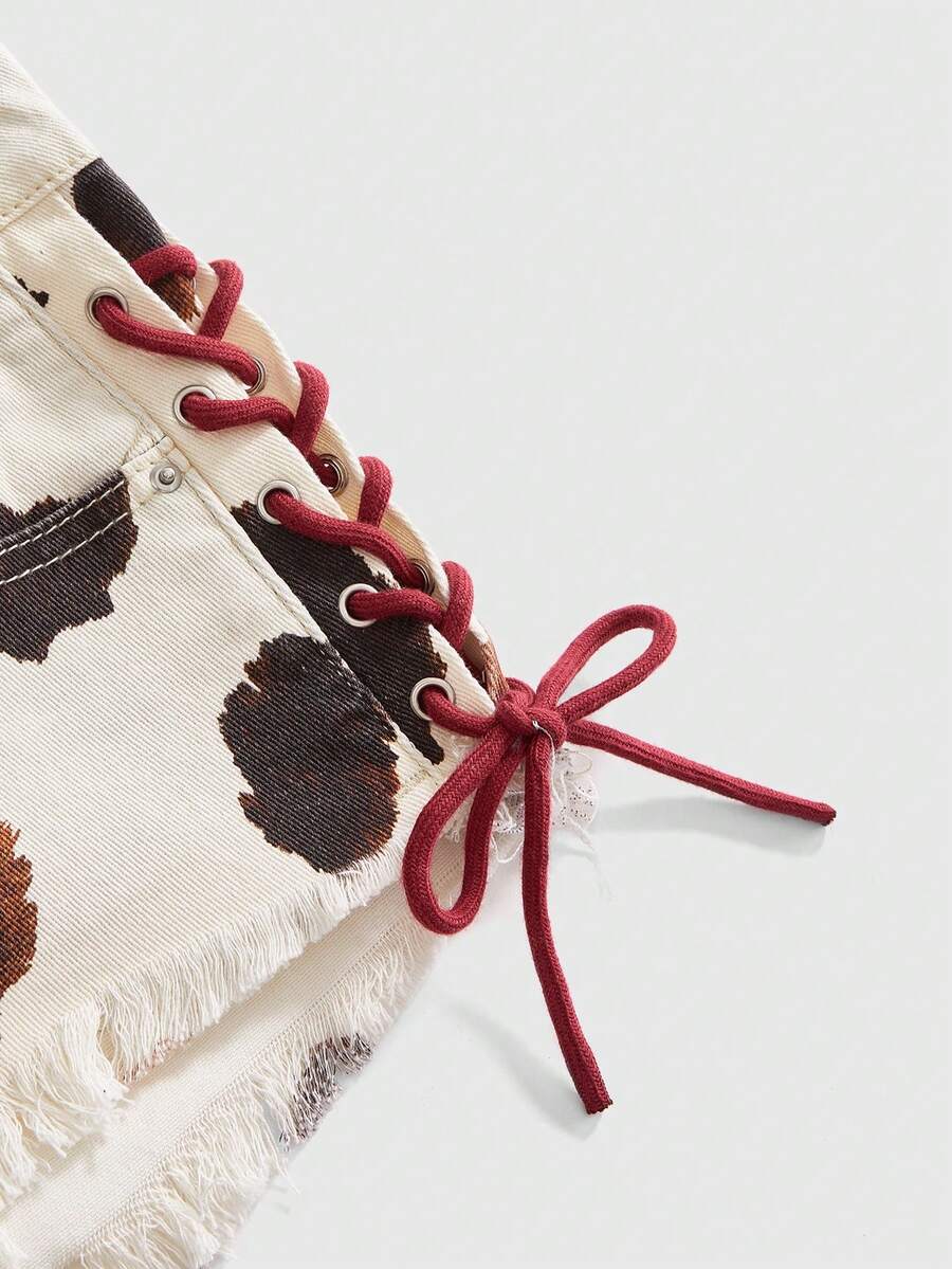 Women's Y2K low waist camo mini skort shorts featuring lace-up knot details, grommet eyelets, graphic lettering pattern, and a zipper fly.