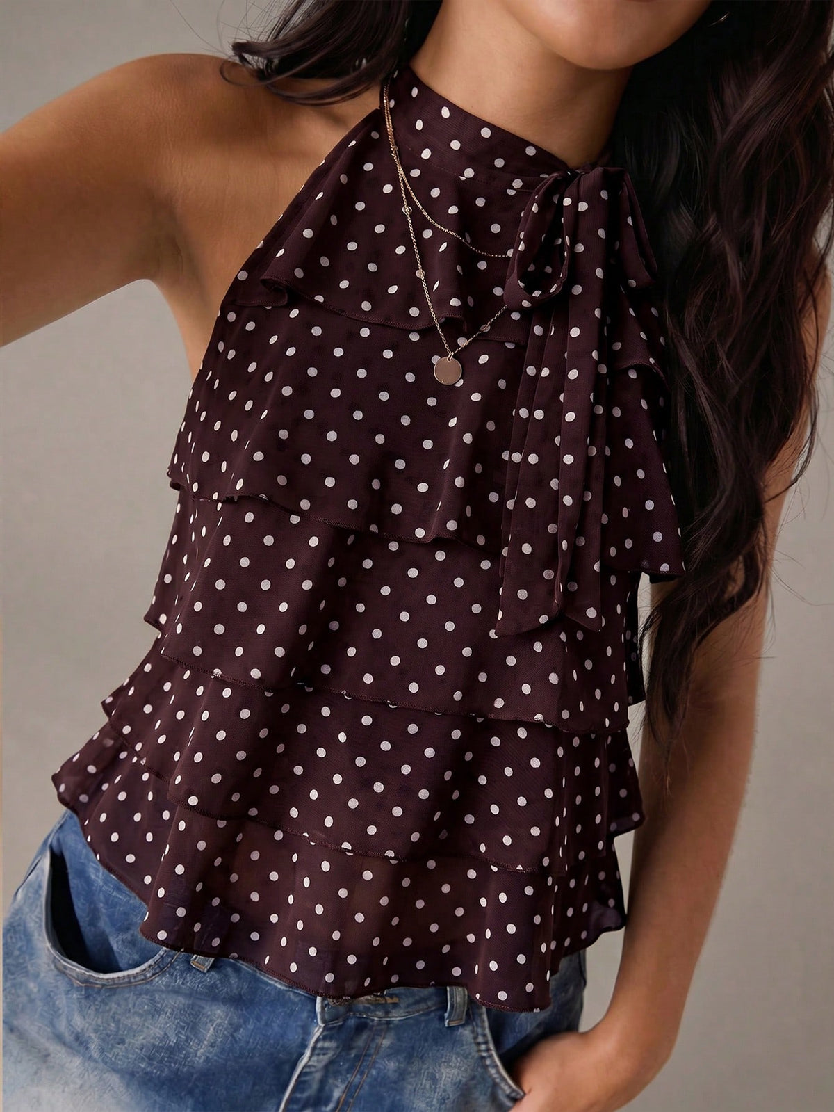 Women's sleeveless stand collar top in rib-knit fabric featuring button and hollow-out details.
