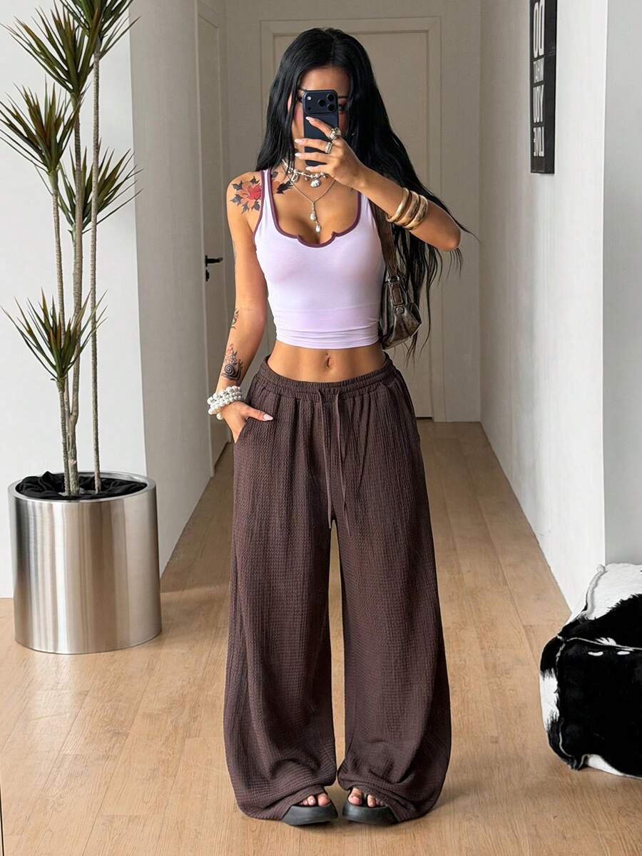 Women's loose fit straight leg lounge pants in textured knit fabric featuring an elastic drawstring waist and side pockets