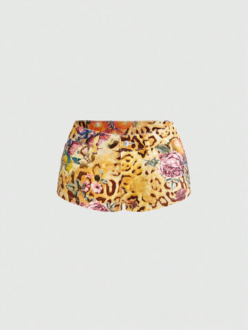 Women's yellow ultra low waist mini denim shorts featuring floral and leopard print with button zipper closure and pockets.