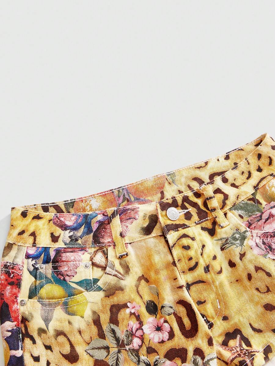 Women's yellow ultra low waist mini denim shorts featuring floral and leopard print with button zipper closure and pockets.