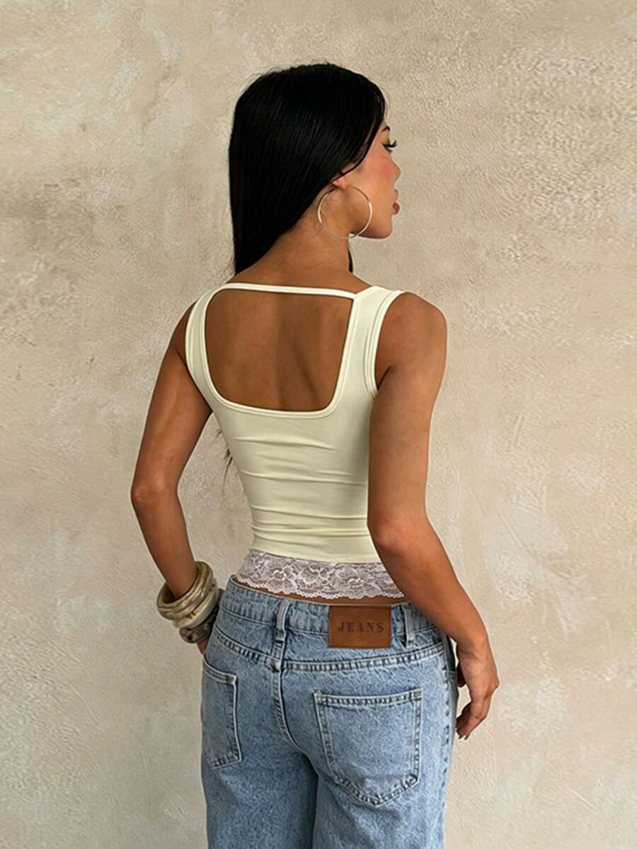 Women's white sleeveless crop tank top with contrast lace details, strap neckline, and graphic plant pattern in a slim fit.