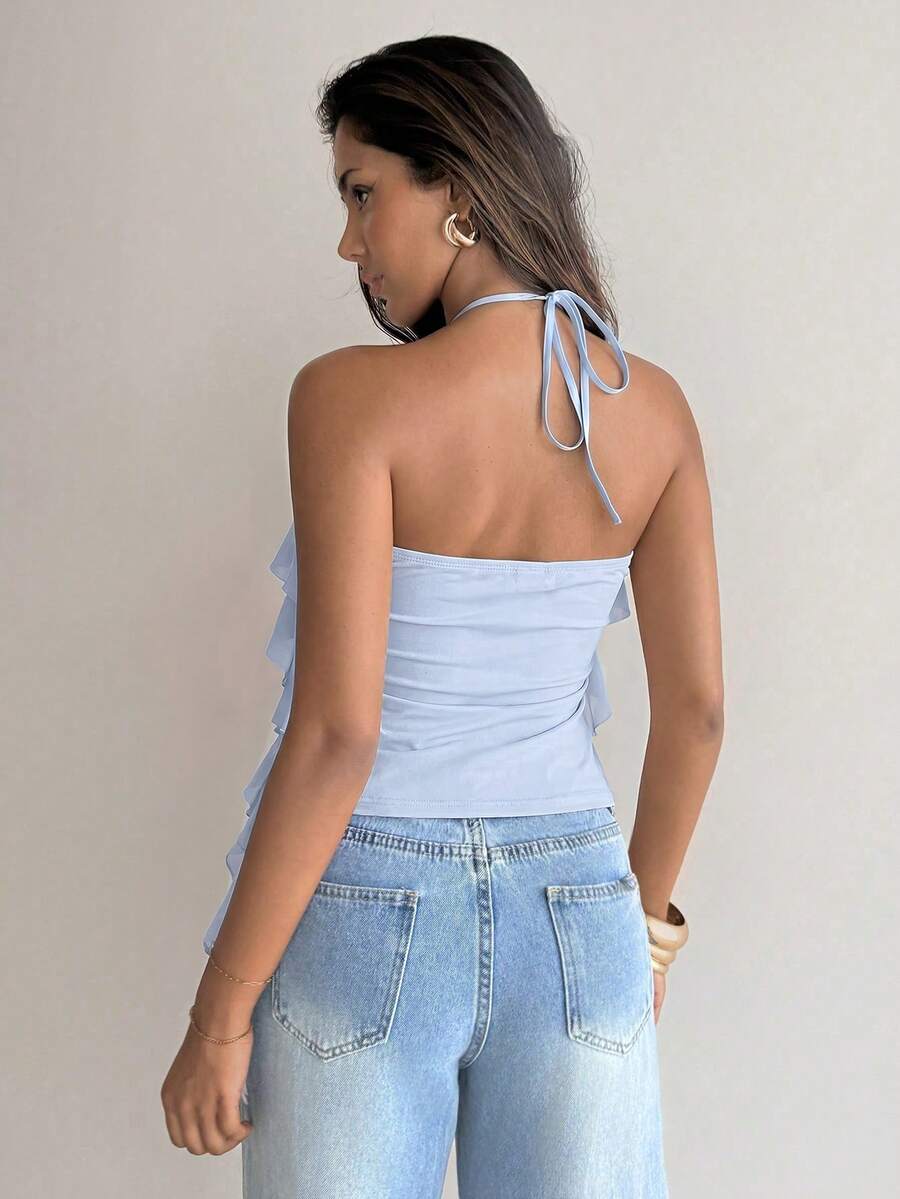 Women's sleeveless halter neck top featuring tiered ruffle layers, a backless cut, and an asymmetrical hem.