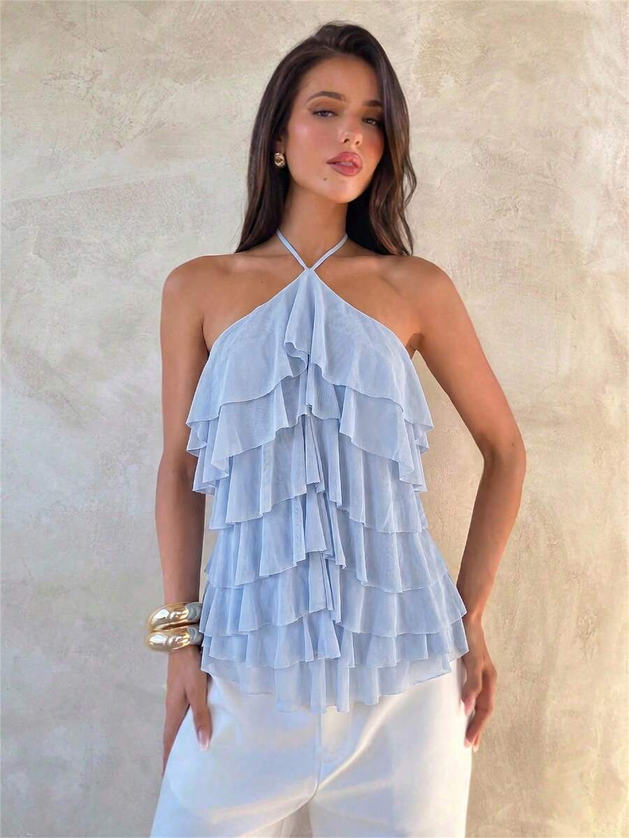 Women's sleeveless halter neck top featuring tiered ruffle layers, a backless cut, and an asymmetrical hem.