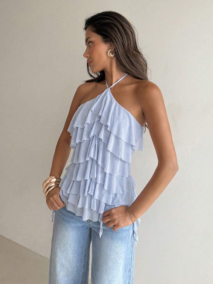 Women's sleeveless halter neck top featuring tiered ruffle layers, a backless cut, and an asymmetrical hem.