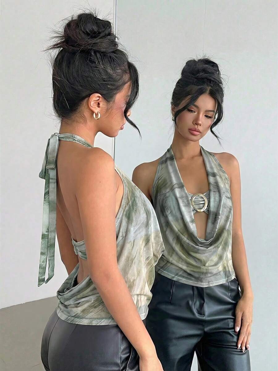 Brown and white polka dot semi-sheer halter camisole top with a plunging neckline, backless design, draped front, and metallic studded embellishments.