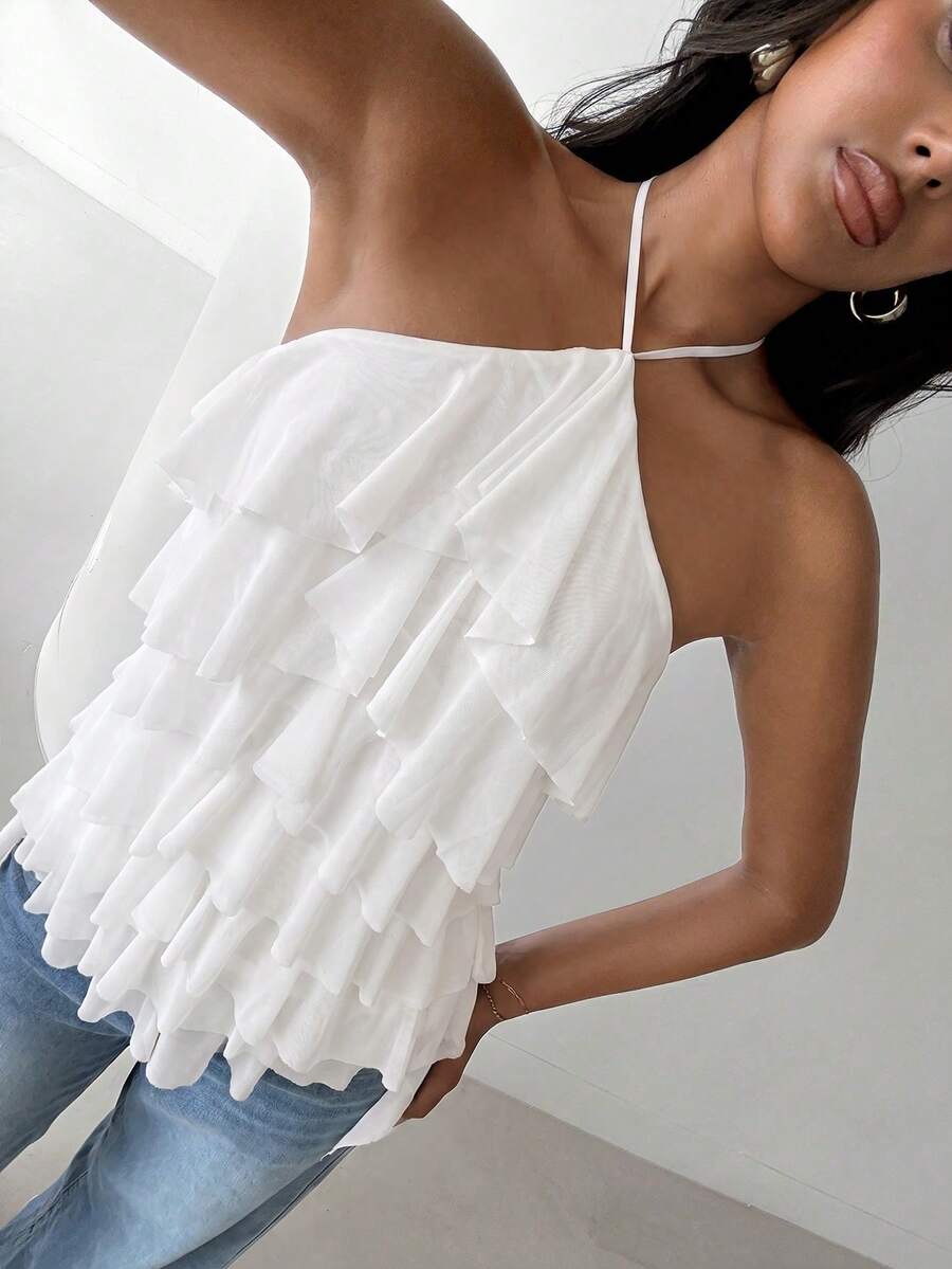 Women's sleeveless halter neck top featuring tiered ruffle layers, a backless cut, and an asymmetrical hem.
