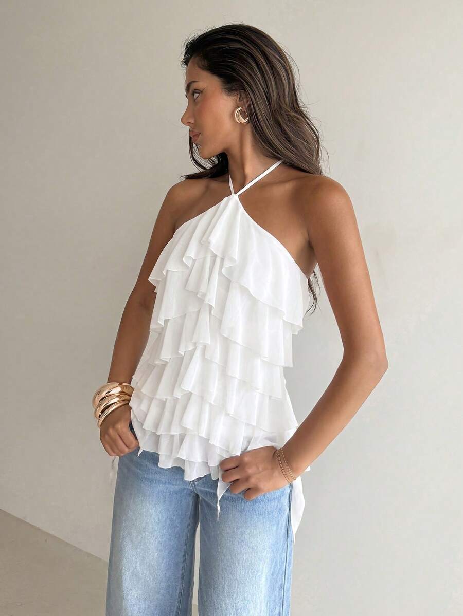 Women's sleeveless halter neck top featuring tiered ruffle layers, a backless cut, and an asymmetrical hem.
