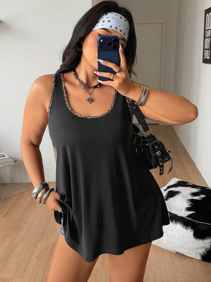 Women's camouflage print tank top featuring a scoop neckline and knitted stretch fabric in army green.