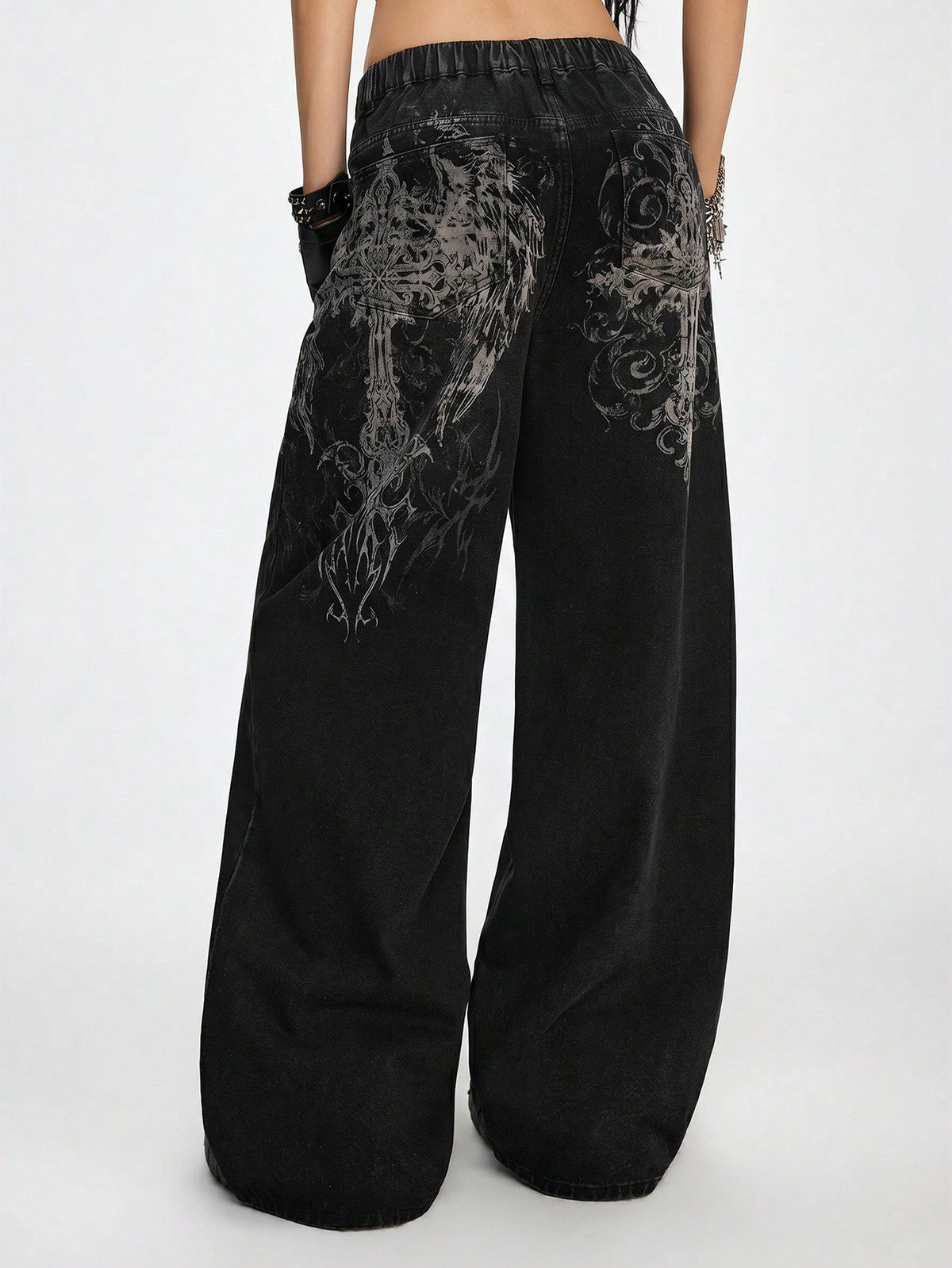 Women's gothic cross print baggy wide leg jeans made from denim with zipper fly and loose fit.