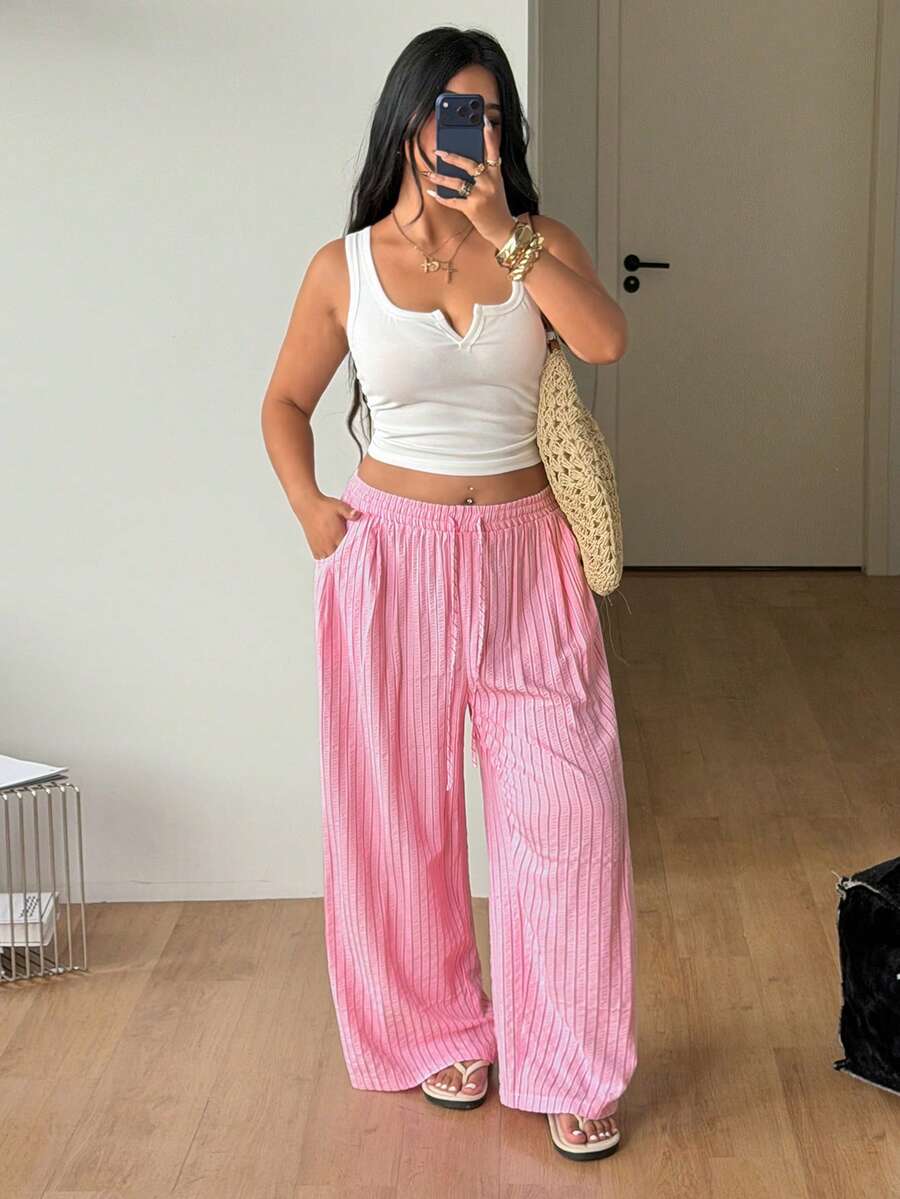 Plus size women's striped loose straight leg cropped pants with pleated detailing and side pockets
