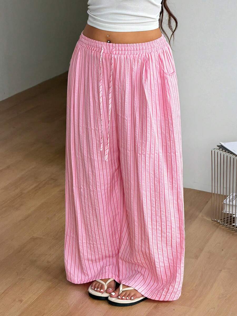 Plus size women's striped loose straight leg cropped pants with pleated detailing and side pockets